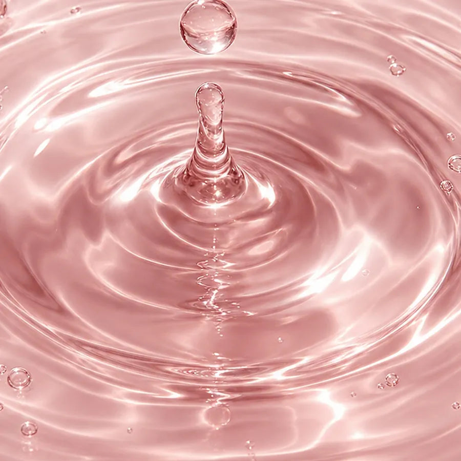 A drop landing in clear blush serum