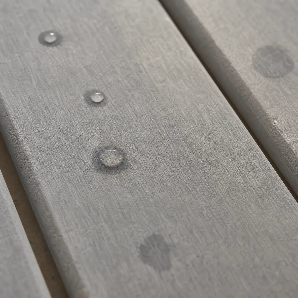 Water drops soaking into the grey stone